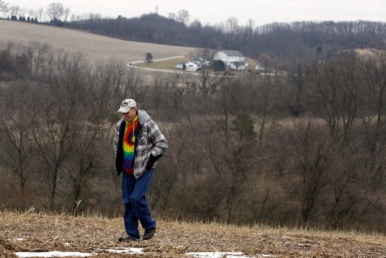 Mike Carpenter, uncle of Greg Longenecker, walks the Berks County field where Longenecker was killed by a Pennsylvania Game Commission bulldozer. Carpenter's lawsuit accuses Pennsylvania State Police of gross recklessness for using a bulldozer to chase and kill Longenecker, who had fled after being caught growing marijuana on public land.
