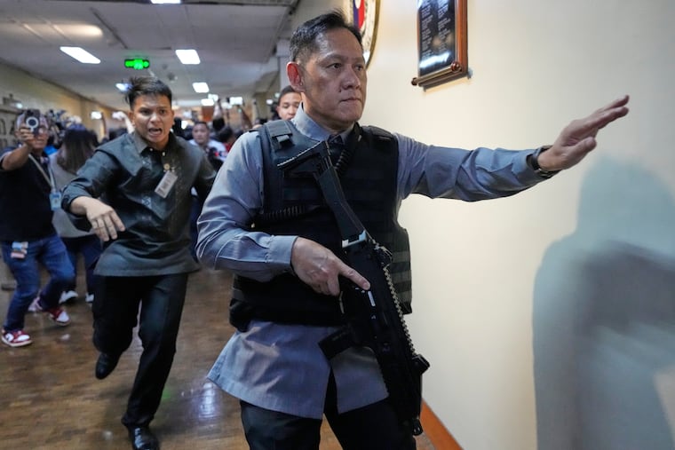 Senate security run after gunfire was heard along a hallway at the Philippine Senate on Wednesday.