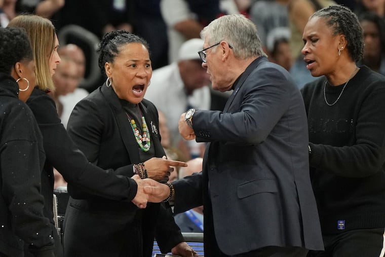 Geno Auriemma (second from right) argued with Dawn Staley at the end of South Carolina's win over Connecticut, and the two head coaches had to be separated by their assistants.