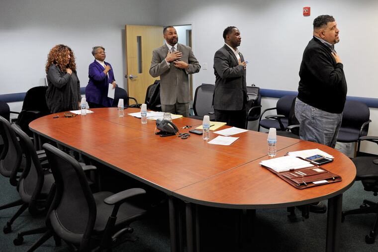 The Willingboro Council salutes the flag before a meeting. From left are Jacqueline Jenkins, Sarah Wooding, Michael Armstrong, Nathaniel Anderson and Martin Nock.