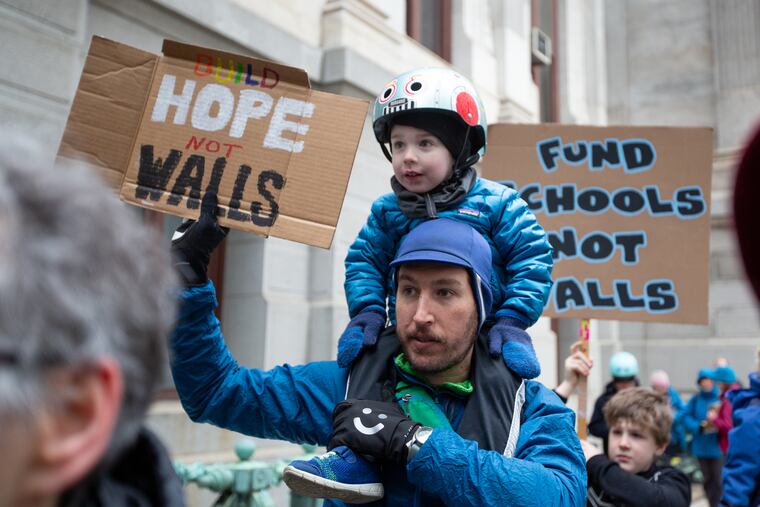 Michael Hulburt, of South Philadelphia, holds his son, Patrick, 3, at Philadelphia City Hall Feb. 18, 2019. A group from Philadelphia and surrounding suburbs, which was organized by Move On, protested against Trump's declaration of national emergency in order to build a wall on the Southern U.S. border.