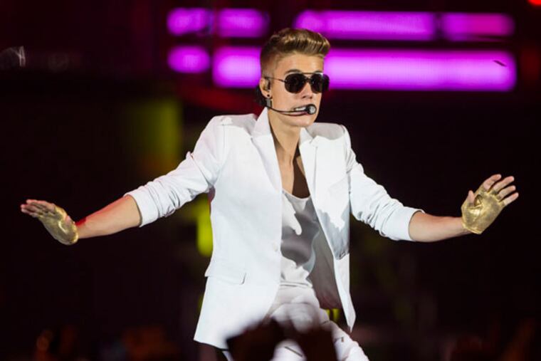 FILE - A Sunday, March 31, 2013 photo from files showing Canadian singer Justin Bieber performing on stage during the "I Believe Tour " in Berlin, Germany. (AP Photo/Gero Breloer)