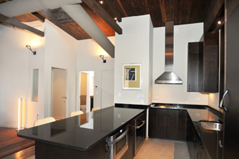 Architect David Traub renovated an old carriage house on Cambridge Street in Philadelphia. The kitchen in the second-floor apartment has an open design. (Sharon Gekoski-Kimmel / Staff Photographer)
