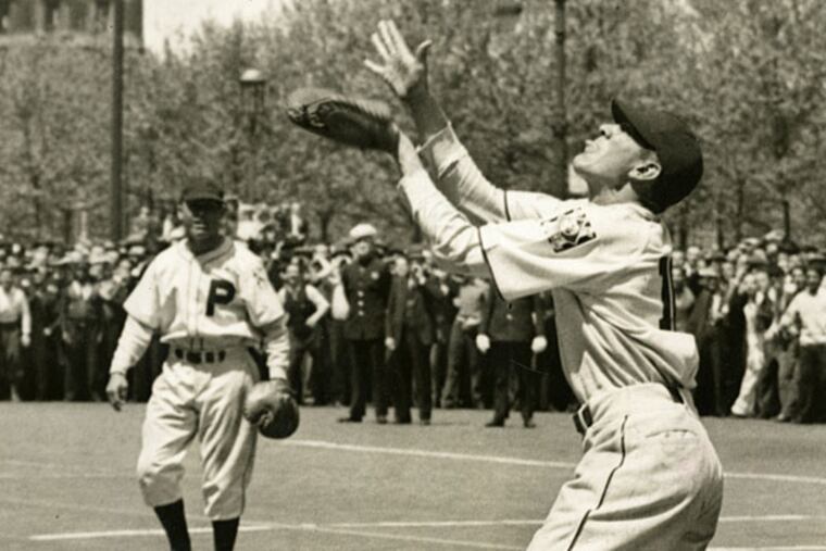 On May 10, 1939, after several misses Phillies' rookie catcher Dave Coble, 26-years-old, caught a ball tossed from Philadelphia's City Hall Tower 500 feet above him as a publicity stunt for the team. (Philadelphia Bulletin photo)