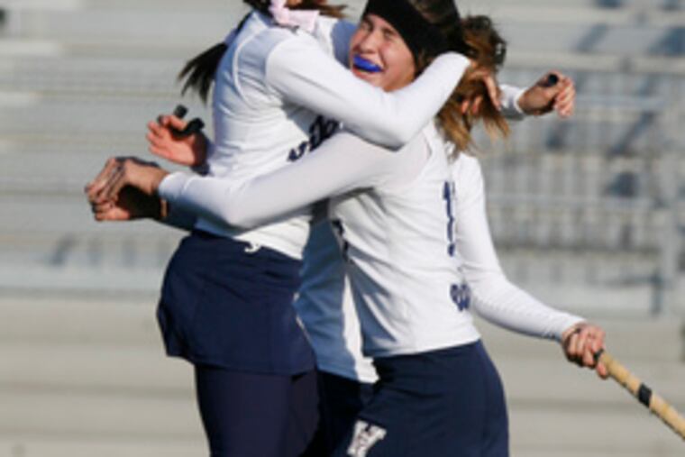 Mitchell (left) leaps into the arms of teammate Jaclyn Beasley as they celebrate their Tournament of Champions title.
