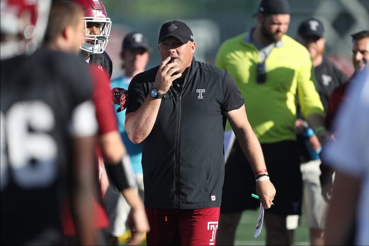Coach Geoff Collins assembles the team during warm-ups at a practice.