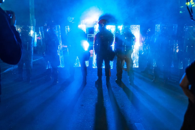 Law enforcement officers in riot gear stand off against anti-ICE protesters outside the Delaney Hall detention center in Newark on May 30.