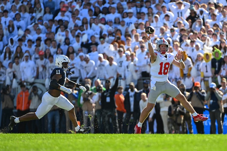 Ohio State quarterback Will Howard throws a pass while being pressured by Penn State defensive end Abdul Carter (11) during the second quarter Saturday.