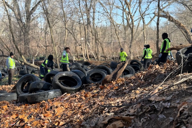 File: On March 19, Philadelphia city workers began removing an illegal dump of thousands of tires at Tacony Creek Park.