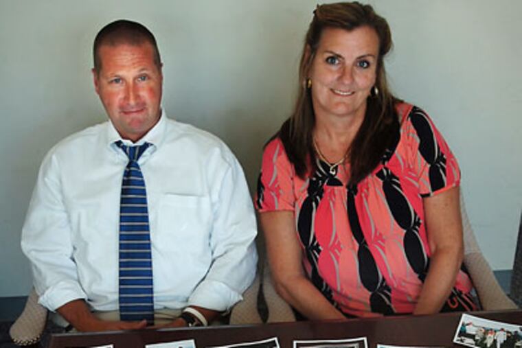 At Aqua Pennsylvania in Willow Grove, Robin MacNamara, (left) with photos he found after the fire at Riverwalk at Millennium. Coworker Rose Fellin (right). (Sharon Gekoski-Kimmel/Inquirer)