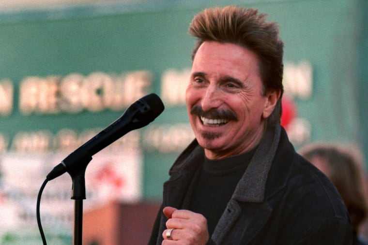 Chuck Negron, former lead singer of Three Dog Night, sings to a crowd during a Christmas Eve party in 1997 at the Union Rescue Mission in Los Angeles.