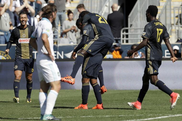 Philadelphia Union midfielder Derrick Jones (21) celebrates with Roland Alberg (center left), C.J. Sapong (17) and Haris Medunjanin (6) after Alberg scored the goal that sealed a 2-0 win over the Seattle Sounders.