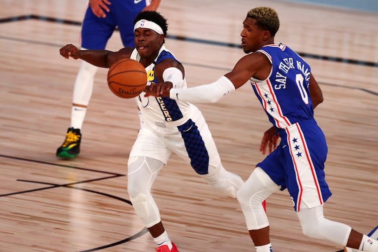 Sixers shooting quard Josh Richardson, here battling Indiana Pacers guard Aaron Holiday (3) for a loose ball, attempted only four shots against the Pacers on Saturday night.