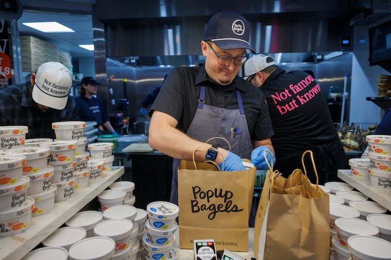Bagel chef Josh Jastrzembski bagging product at the newly opened PopUp Bagels in Ardmore, PA.