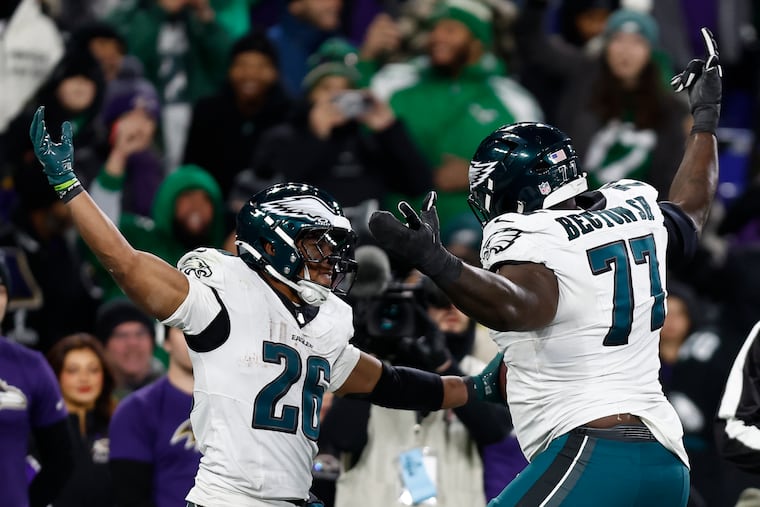 Eagles running back Saquon Barkley celebrates his fourth quarter touchdown run with teammate offensive tackle Mekhi Becton against the Baltimore Ravens on Sunday, December 1, 2024 at M&T Bank Stadium in Baltimore.