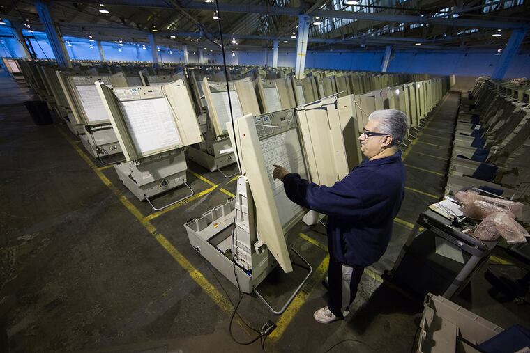 A technician prepares voting machines to be used in the 2016 presidential election in Philadelphia. A top Republican state senator is drafting legislation to prevent Gov. Tom Wolf from forcing Pennsylvania counties to buy new voting machines, a priority for the Democratic governor to ensure the machines are in place in time for the 2020 presidential election.