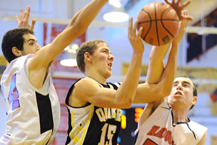 Haddonfield big men Mike Lacatena, left, and Chris Biddle defend Moorestown senior Alex Howard. (Clem Murray/Staff Photographer)