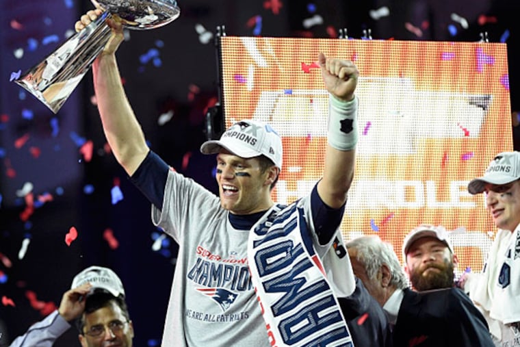 New England Patriots quarterback Tom Brady (12) hoists the Vince Lombardi Trophy after defeating the Seattle Seahawks in Super Bowl XLIX at University of Phoenix Stadium. (Kyle Terada/USA TODAY Sports)