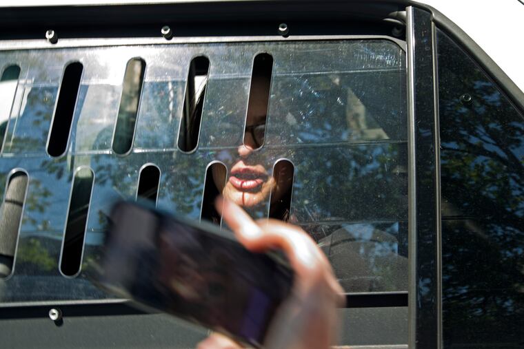 A pro Nicolas Maduro supporter Adrienne Pine is arrested, during the eviction of Maduro's supporters from the Venezuelan Embassy in Washington, Thursday, May 16, 2019.