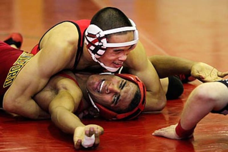 Northeast's Alan Huang pins Frankford's Calvin Oquendo in a 135-pound match. (Laurence Kesterson/Staff Photographer)