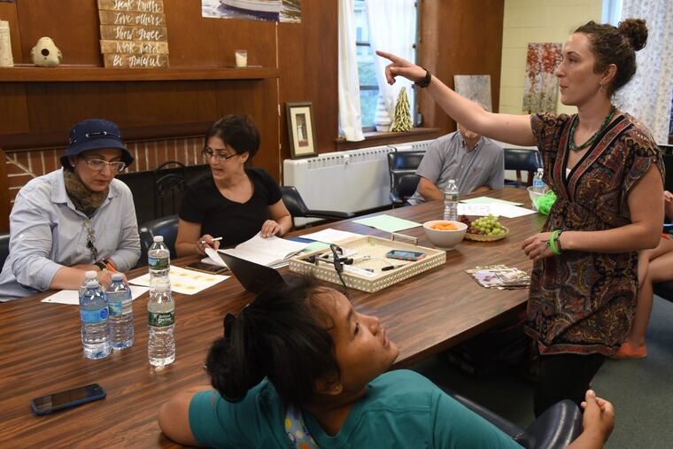 Alison DiGiacomo (standing) teaches English to new immigrants Maria Cinhoihniang (front) from Myanmar; Rawnak Saaeed (seated, left) from Iraq; and Rola Hanan (right) from Syria. DiGiacomo launched the volunteer ‘Crossing the Gap’ program in May to help refugees and immigrants assimilate in South Jersey.