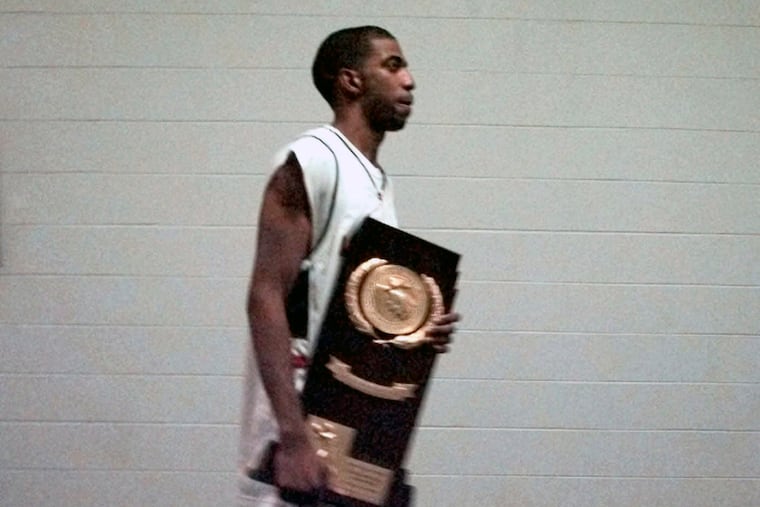 Connecticut's Richard Hamilton, a former Coatesville High star, carries the NCAA championship trophy after the Huskies defeated Duke, 77-74, in 1999.