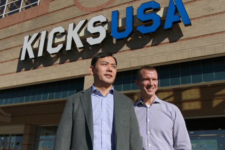 Owner John Lee ( L ) and VP of store operations Marty Badour at the Cottman Avenue KICKSUSA store, November 18, 2013. (DAVID SWANSON/Staff Photographer)