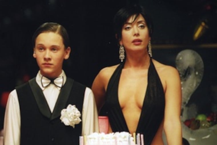 Dima Martynov (left, with Zhanna Friske) plays the malevolent vampire boy in "Day Watch," the second in a spooky trilogy.