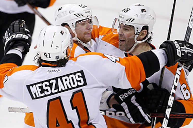 Jaromir Jagr (right) scored the game-winning goal with 44 seconds left in overtime. (Trevor Hagan/Canadian Press/AP)