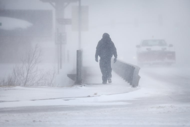 A man crosses Crow Creek during a blizzard on Wednesday, March 13, 2019, in Cheyenne, Wyo. Heavy snow hit Cheyenne about mid-morning Wednesday and was spreading into Colorado and Nebraska.