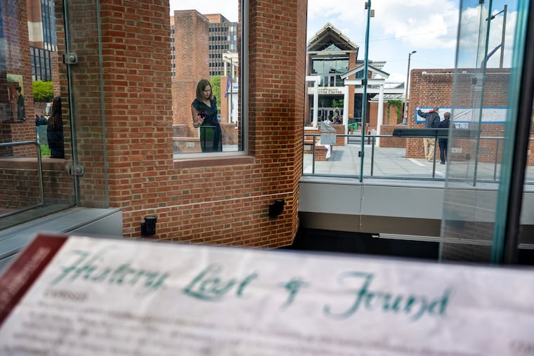 Carol Quillen (rear, left), president and CEO of the National Trust for Historic Preservation, visits the President’s House in Independence National Historical Park in April, looking at signs and notes left by visitors.