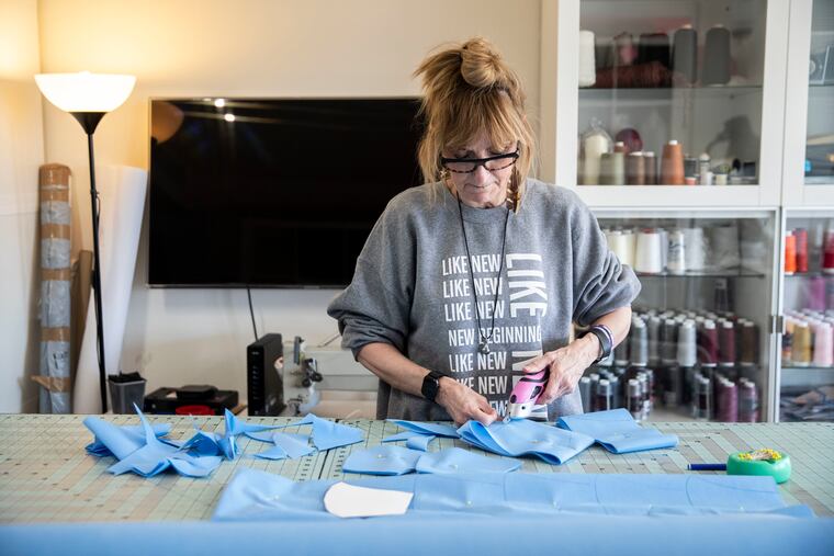 Fashion designer Nancy Volpe Beringer demonstrates the process for making protective masks at her studio in Philadelphia, Pa. on Tuesday, March 24, 2020. She started making masks last Friday using a modified pattern she found online, to donate to people working on the front lines of the coronavirus.
