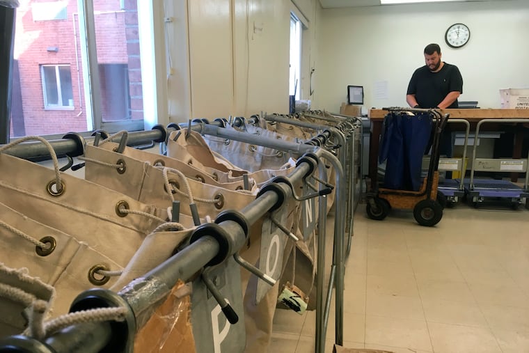 In this Oct. 4, 2018, Pennsylvania Corrections Department mail inspector Brian Strawser sorts inmate mail at Camp Hill state prison in Camp Hill, Pa.