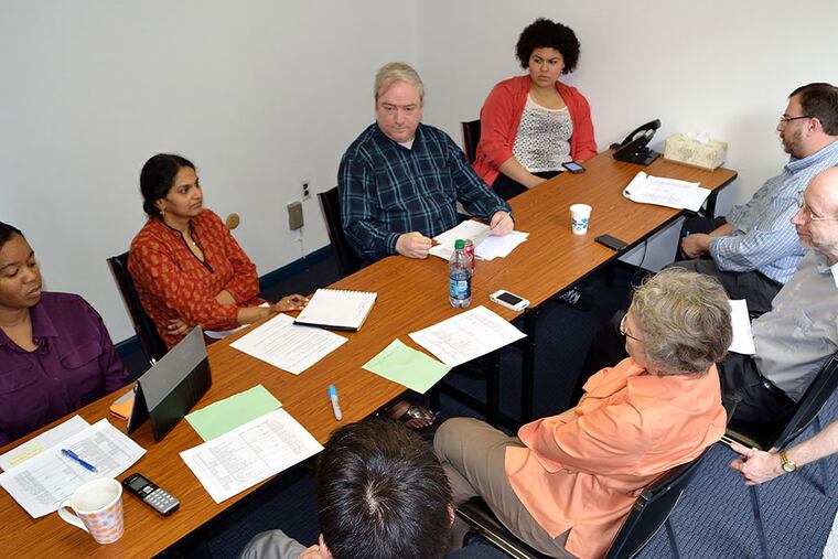 Gathering to plan their 20th anniversary celebration are (clockwise from far left) Wendy Harris, Neeta Patel, Tim Cravens, Catherine Quero, Shawn Phillips, Paul Socolar, Dale Mezzacappa, and David Limm. C.F. SANCHEZ / Staff Photographer
