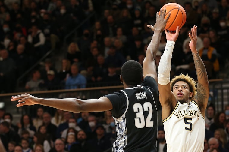 Justin Moore, left, of Villanova shoots over Malcolm Wilson of Georgetown during the 1st half on Feb. 19, 2022 at the Finneran Pavilion at Villanova University.