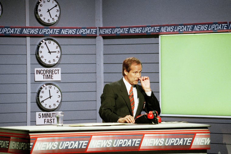 Chevy Chase, host of Fox Network's talk show "The Chevy Chase Show," picking his nose jokingly during taping of the news update segment of the show on Sept. 7, 1993 in Los Angeles.