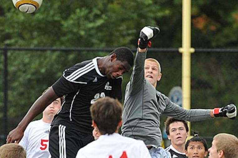 Haddon Township goalie Scott LaPan punches away a corner kick. (Clem Murray/Staff Photographer)
