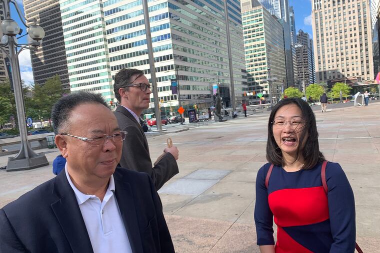 Steve Zhu, president of Philadephia's Chinese Restaurant, with Ling Lin, who closed her Southwest Philadelphia takeout after repeated police citations under the city's "11 o'clock ordinance," even after a judge ruled it didn't apply to her place. The pair were at Thomas Paine Plaza in Center City Philadelphia on Friday, Oct. 4, 2019, to join City Councilman David Oh, lawyers Patricia Yan and Jeremy Frey, and 150 takeout owners and workers to celebrate a legal settlement in which the city pledged to stop enforcing the law, which Oh's office documented was used almost exclusively against Chinese restaurants but not against pizza, coffee and deli shops that stayed open past 11. Ling said she has now opened a North Philadelphia takeout and looks forward to better relations with the city.
