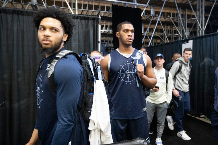 Caleb Daniels, left, and Eric Dixon of Villanova leave Friday's practice in San Antonio.