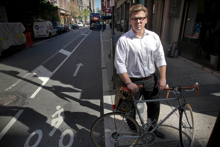 Jonas Maciunas, bicycle commuter and urban strategist, beside a bicycle lane on S. 13th and Walnut St. in center city Philadelphia. ( ALEJANDRO A. ALVAREZ / STAFF PHOTOGRAPHER )