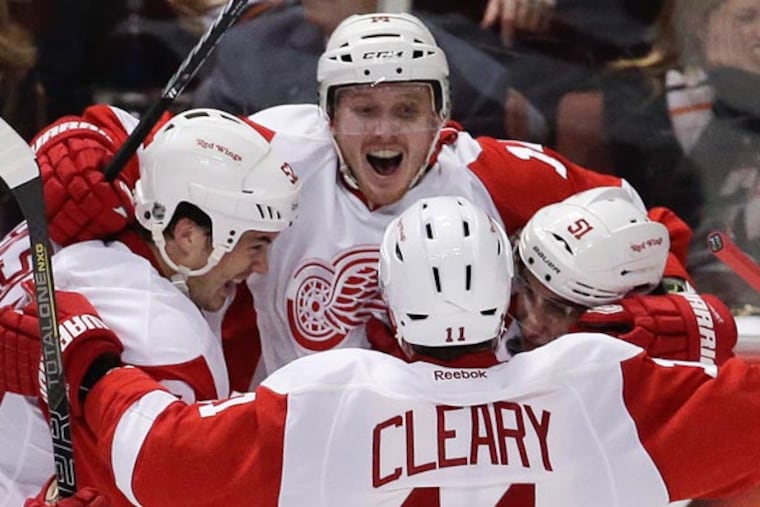 Red Wings center Gustav Nyquist, top, celebates his winning goal with Jonathan Ericsson, left, Daniel Cleary (11) and Valtteri Filppula.
(Chris Carlson / AP)