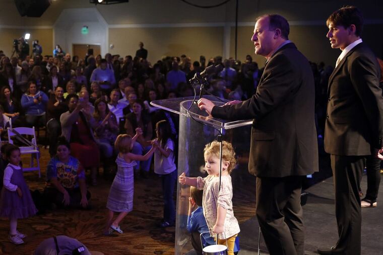 U.S. Rep. Jared Polis, D-Colo., flanked by his partner Marlon Reis, right, and their daughter Cora, age 2, addresses a Democratic Party vote-watch gathering at the Downtown Westin Hotel, in Denver, Tuesday, Nov. 8, 2016.