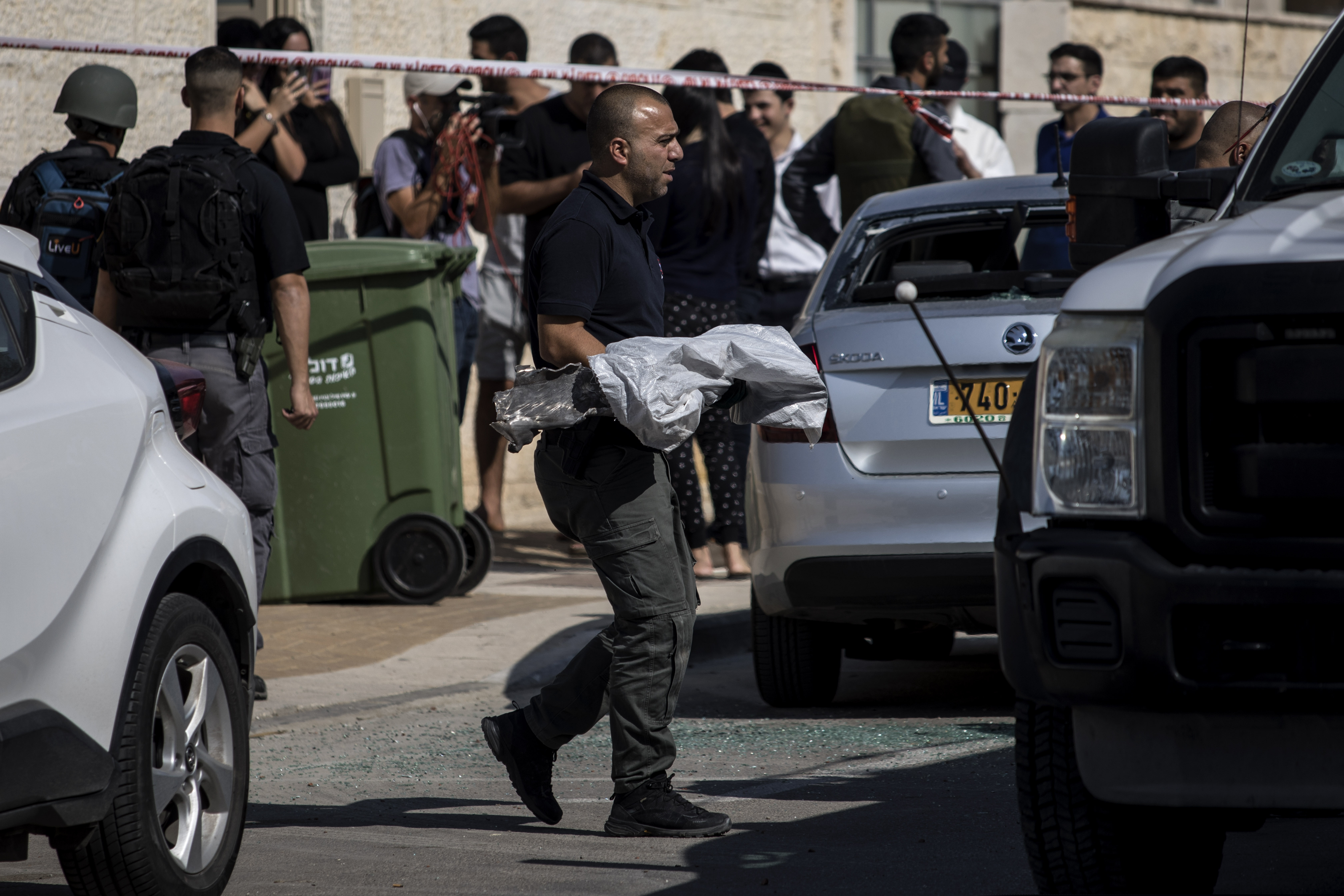 A police sapper carries an exploded rocket from a house it struck in Netivot, Israel, on Tuesday. S senior Islamic Jihad commander was killed earlier in Gaza in a rare targeted attack that threatened to unleash a fierce round of cross-border violence with Palestinian militants.