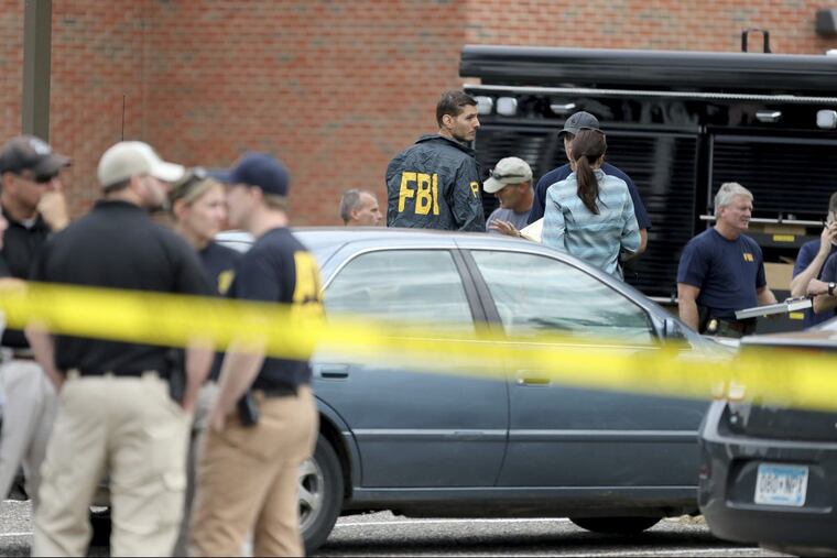Law enforcement officials investigate an explosion at the Dar Al-Farooq Islamic Center in Bloomington, Minn., on Saturday, Aug. 5, 2017.