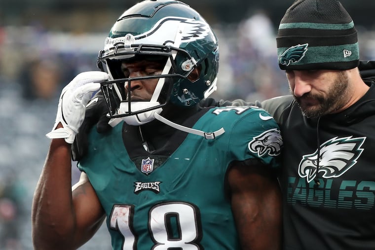 Eagles head coach Nick Sirianni (right) comforting wide receiver Jalen Reagor as they walked off the field after a loss to the Giants on Nov. 28, 2021.