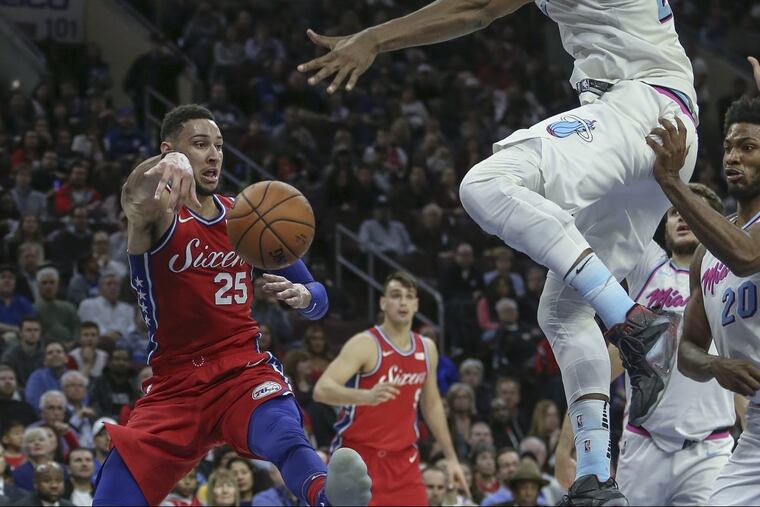Ben Simmons passing under the Heat's Hassan Whiteside during the second quarter Wednesday night.