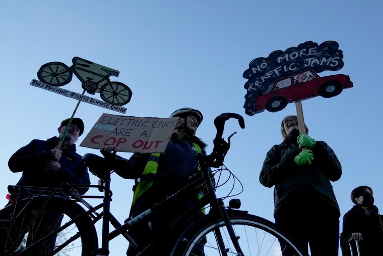 People take part in a pro-cycling demonstration outside the SEC (Scottish Event Campus) venue for the COP26 U.N. Climate Summit, in Glasgow, Scotland, Wednesday, Nov. 10, 2021. The U.N. climate summit in Glasgow has entered its second week as leaders from around the world, are gathering in Scotland's biggest city, to lay out their vision for addressing the common challenge of global warming.