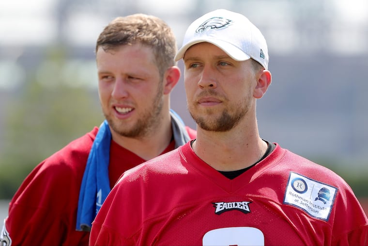 Eagles' Nate Sudfeld, left, and Nick Foles walks off the field after Eagles training camp at the NovaCare Complex in Philadelphia, PA on August 6, 2018. DAVID MAIALETTI / Staff Photographer