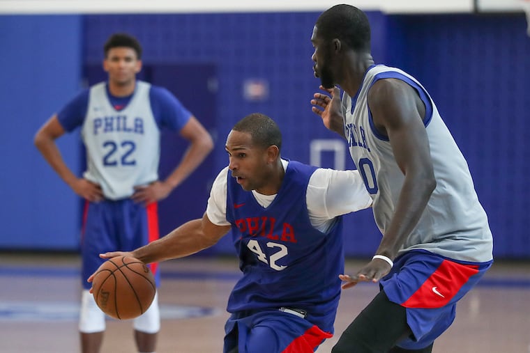 Al Horford (42) drives to the basket while being guarded by Christ Koumadje (20) during a scrimmage.