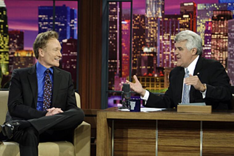 Jay Leno interviews Conan O'Brien in Leno's final taping as host of The Tonight Show. (AP Photo/NBC, Paul Drinkwater)